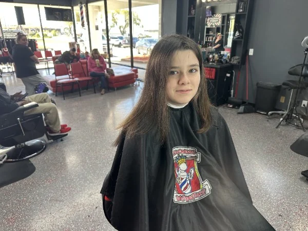 Young client with long hair before the cut